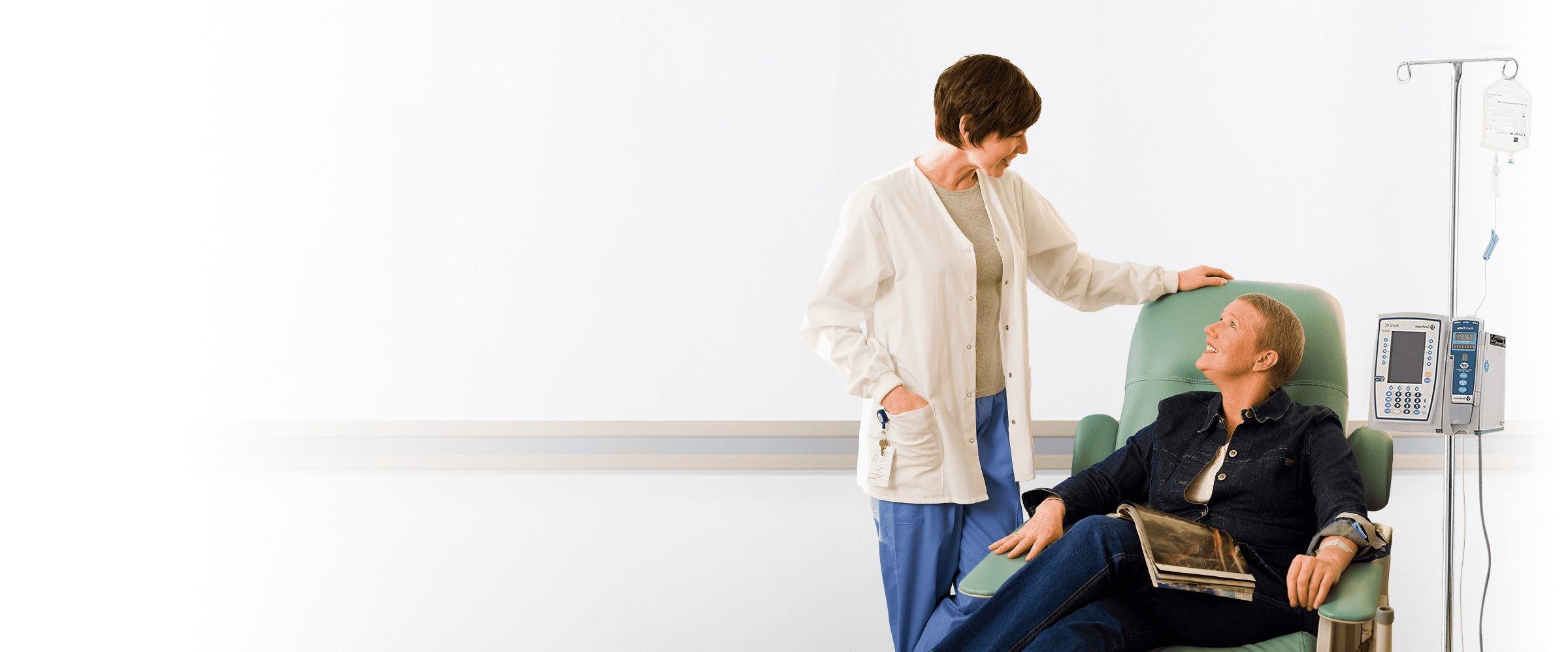 female doctor with female patient in IV chair